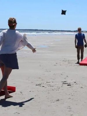 A Couple playing Corn Hole at the Beach