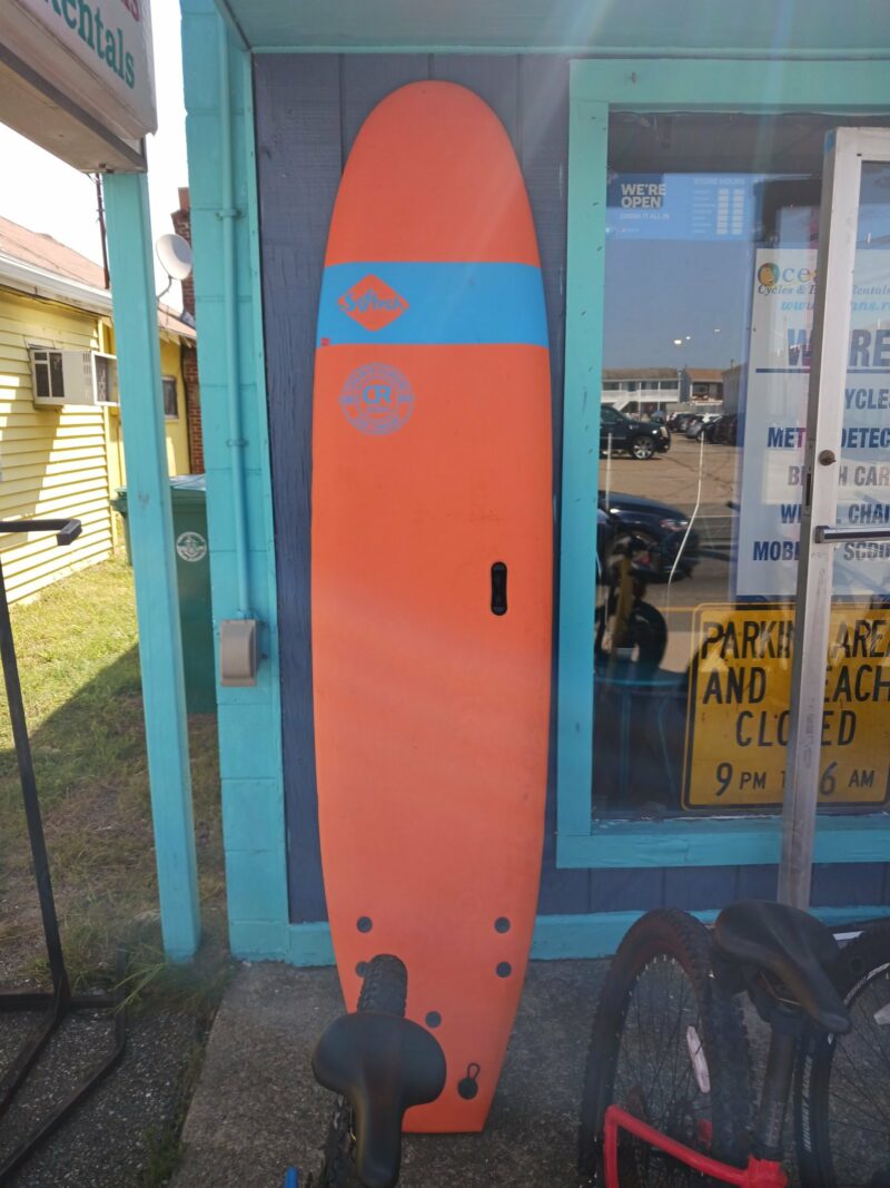 Orange Surfboard propped up against the door
