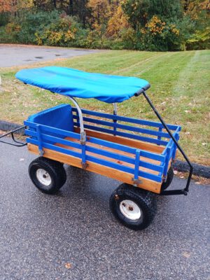 A cart for the beach that features a cover