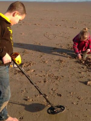 Kids using Metal Detector available for rent at Oceans Rentals