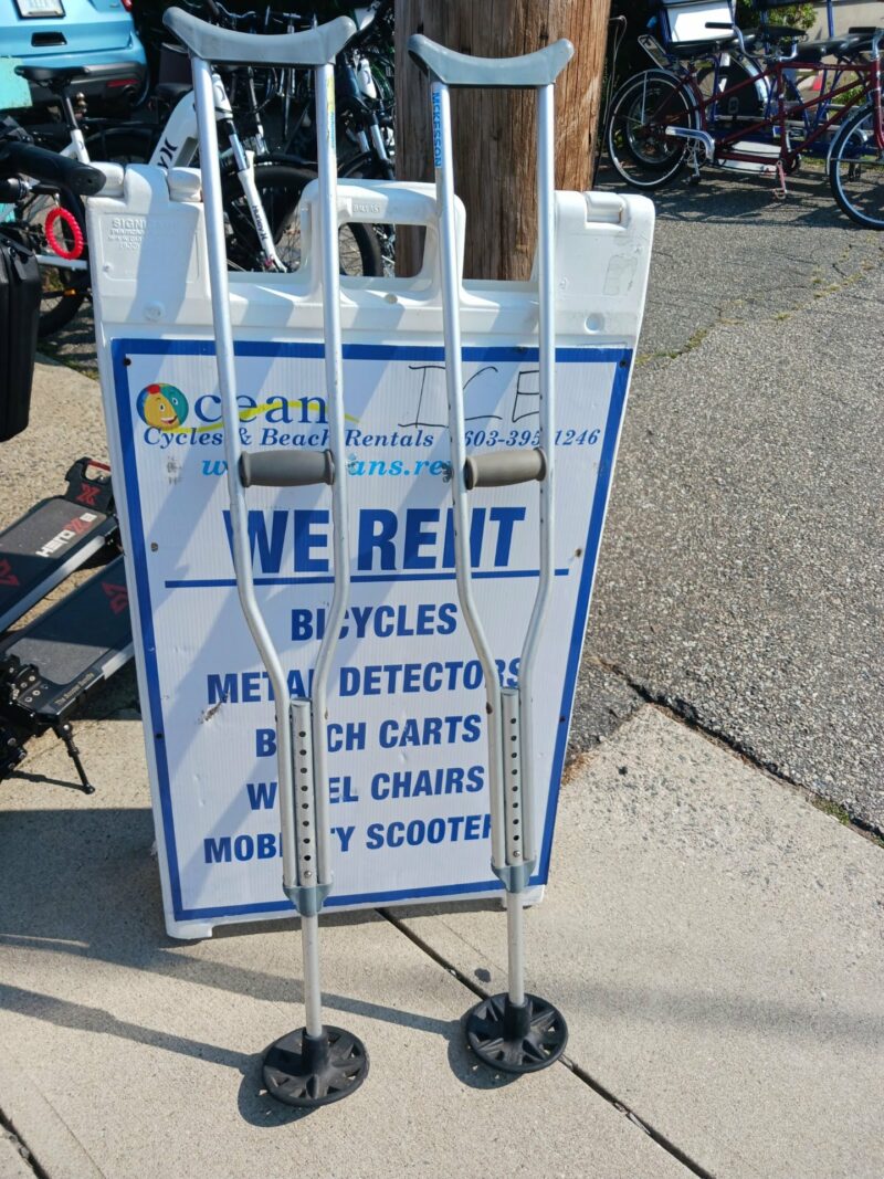 Sand Crutches resting against a rental sign